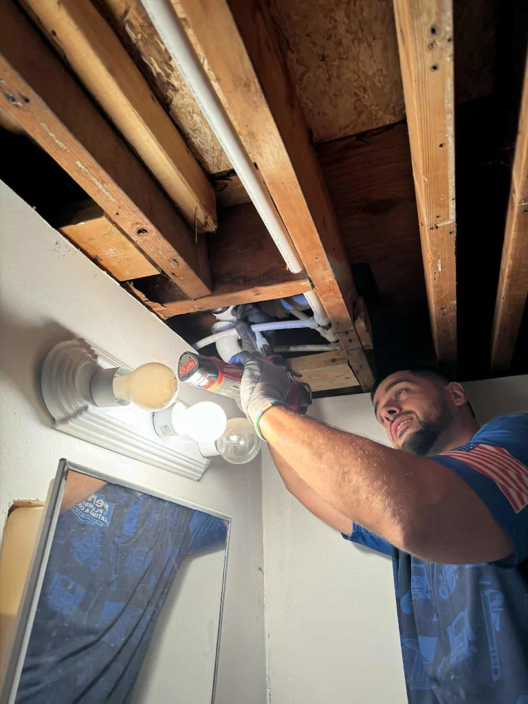 Plumber inspecting pipes