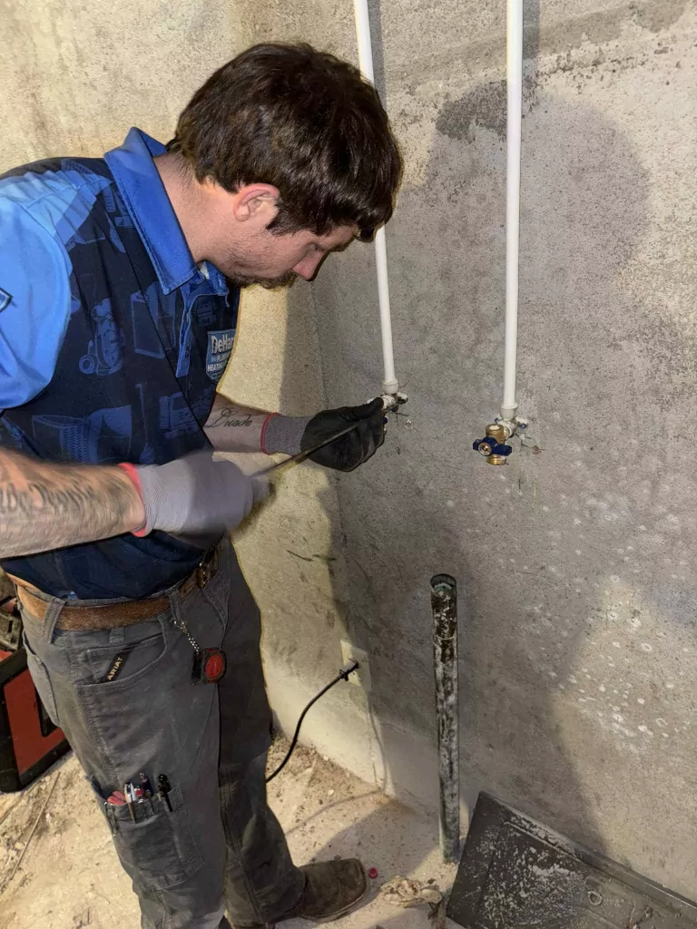 Plumber installing faucet