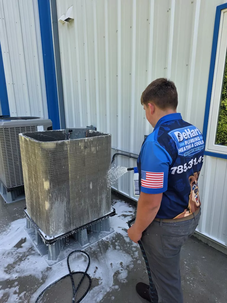De Hart worker washing heat pump
