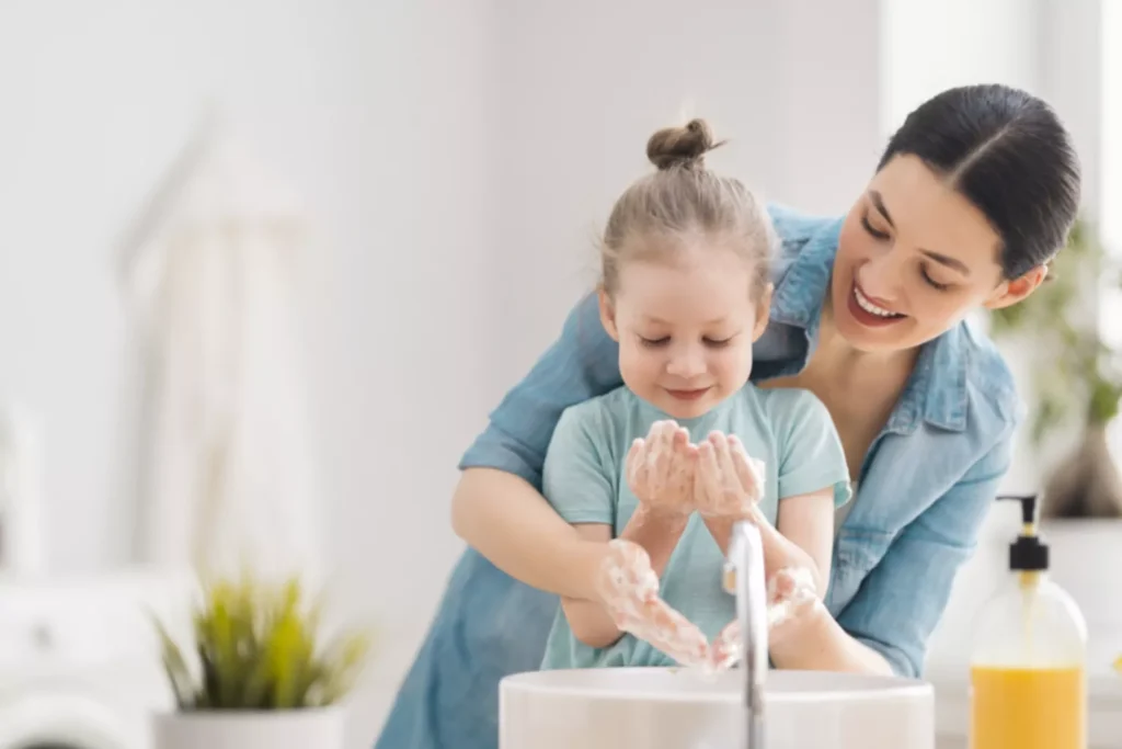 Mother and daughter washing hands