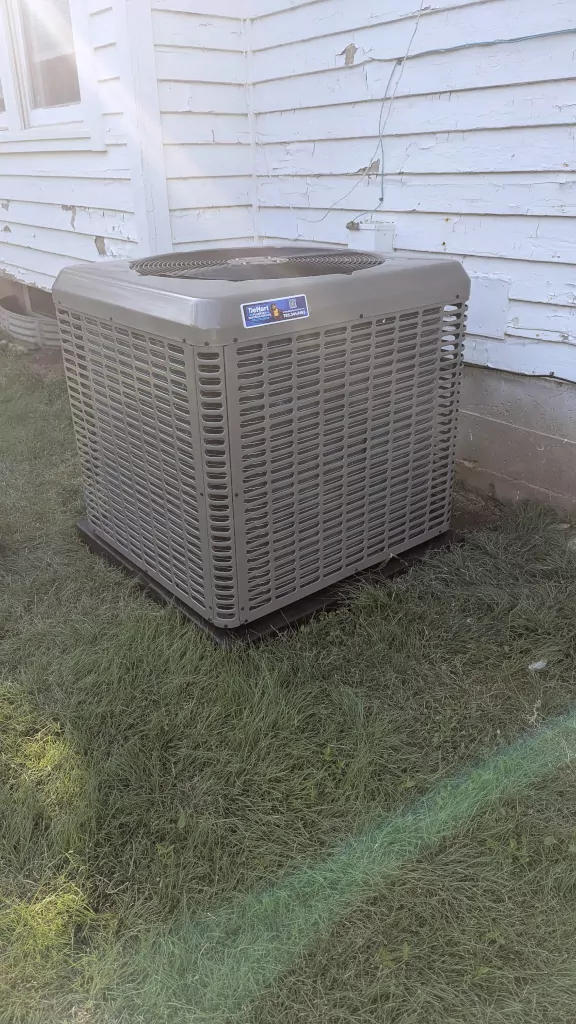 Outdoor heat pump unit on grass