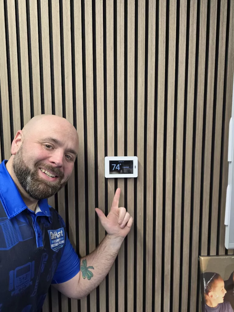 lawrence pointing at thermostat