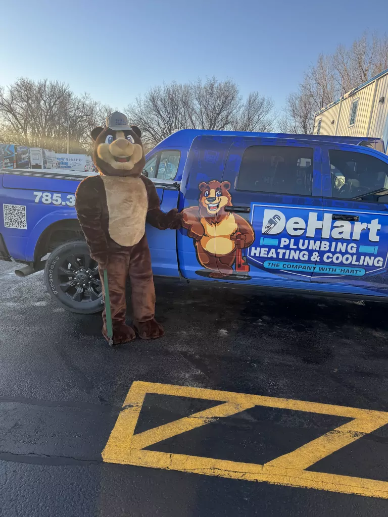 mascot standing next to De Hart truck