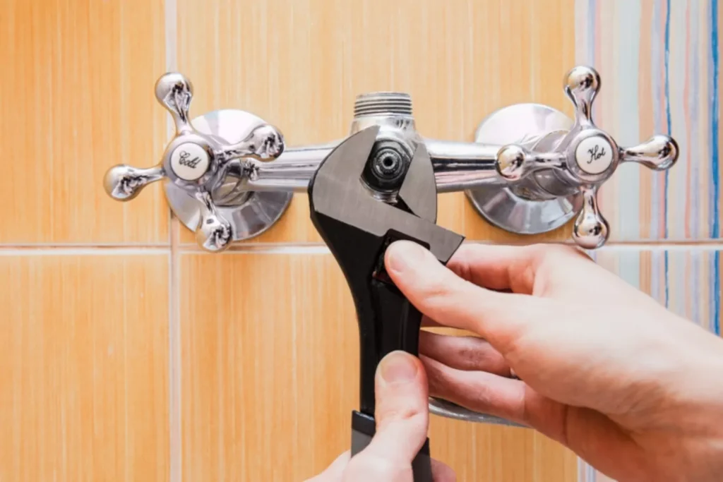 plumber adjusting faucet