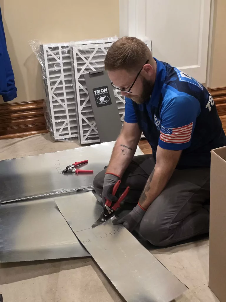 technician installing air filtration system
