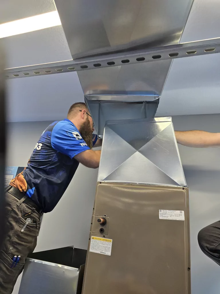 technician inspecting furnace ducts