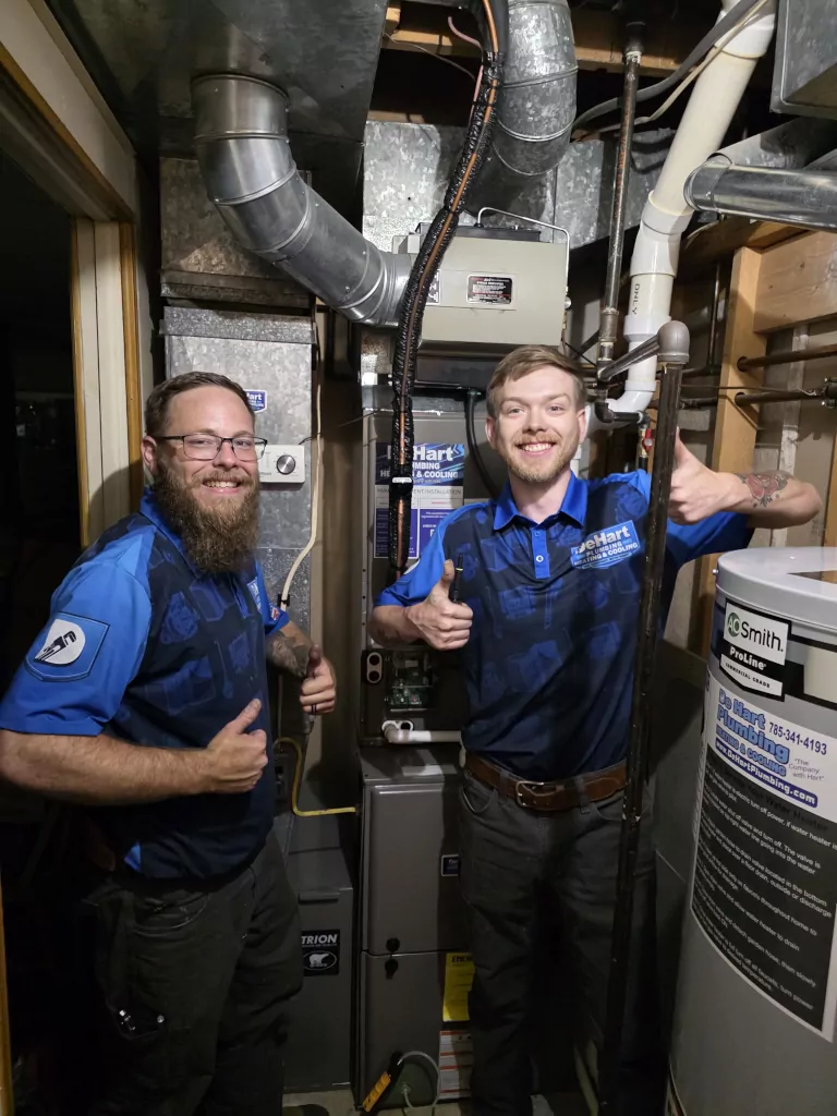 couple of de hart technicians providing service in a house