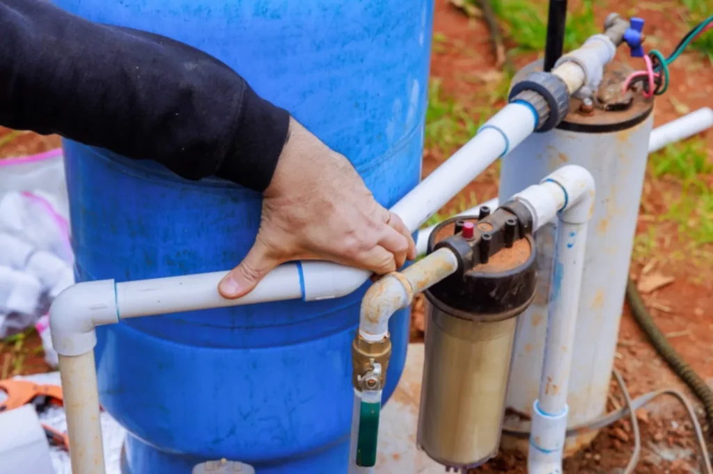 Plumber holding well pump pipes together
