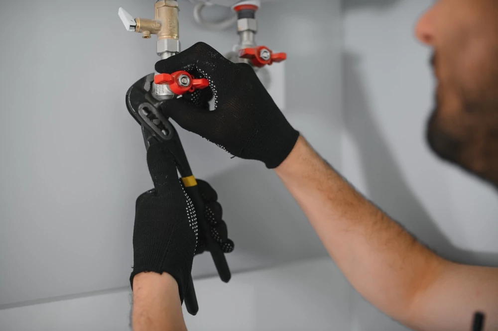 Professional plumber checking a boiler and pipes