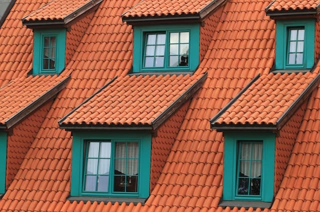 wide view of a roof with green windows
