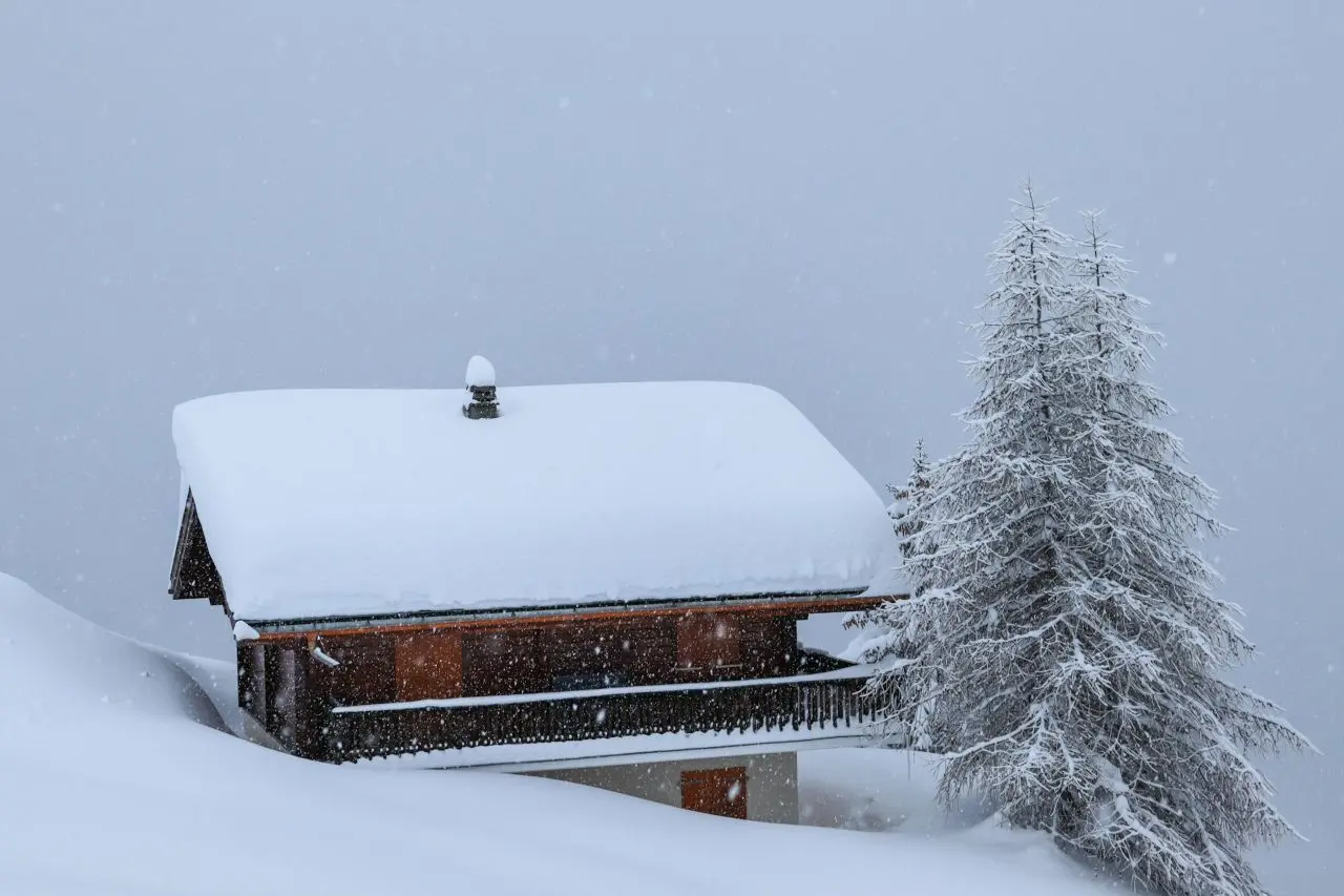House covered with snow during the daytime