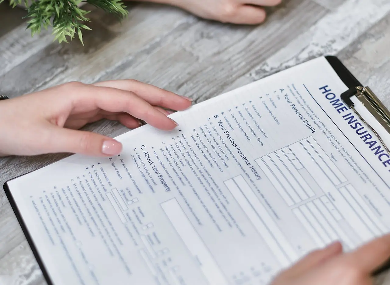 A person holding a home insurance form.