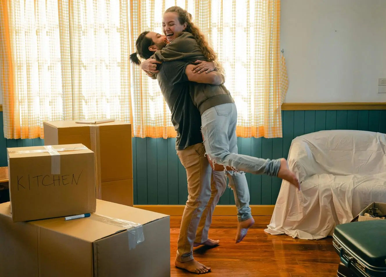 Couple hugging after moving into their new rental.