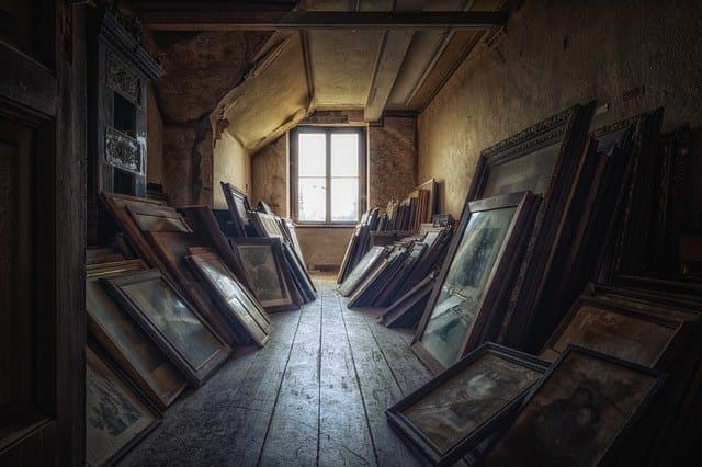 Old paintings stacked in the attic