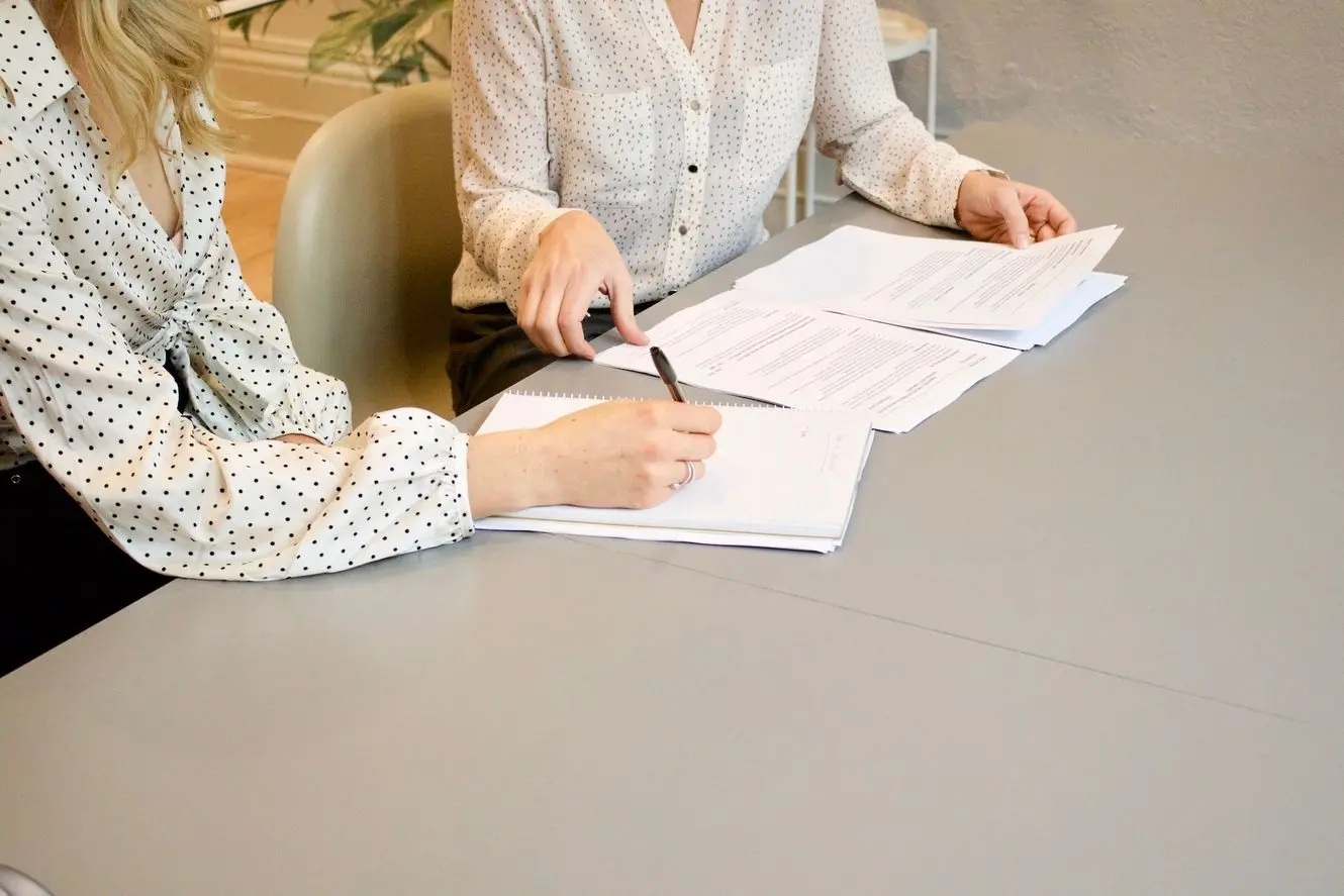 Going over the key things to know about roofing warranties with a professional and making notes