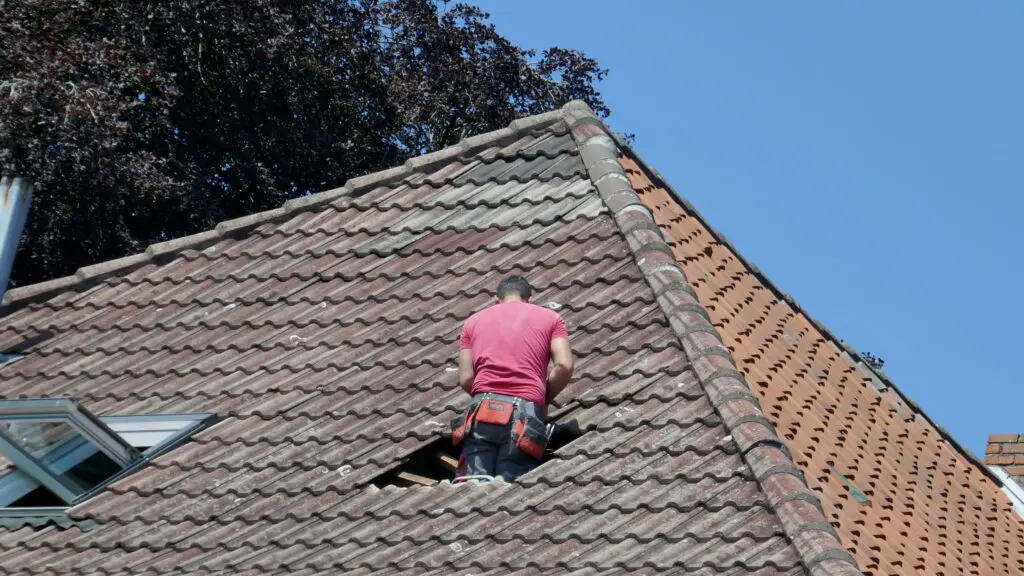 clay tile roof cost man is replacing old tiles