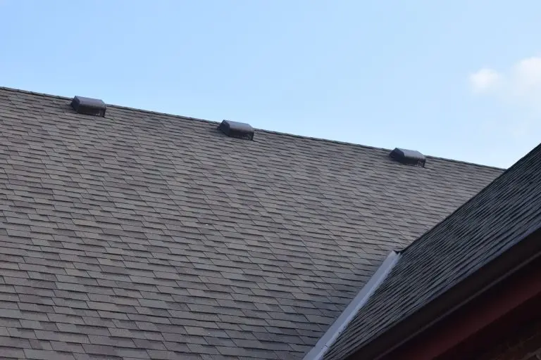 dark grey shingles roof blue sky