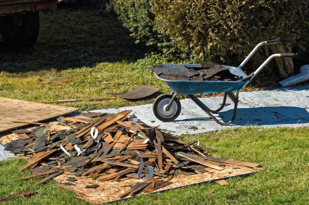 Pile of Torn Off Shingles and Boards From Old Roof