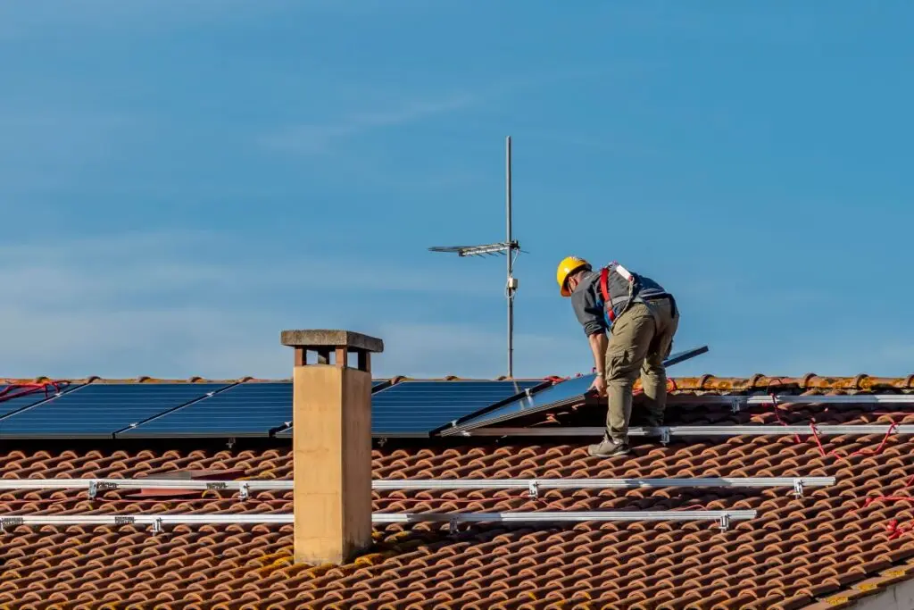 install solar panel orange tiles worker installing panels