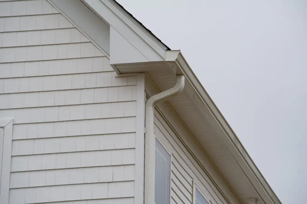 house with new seamless aluminum rain gutters pipe metal