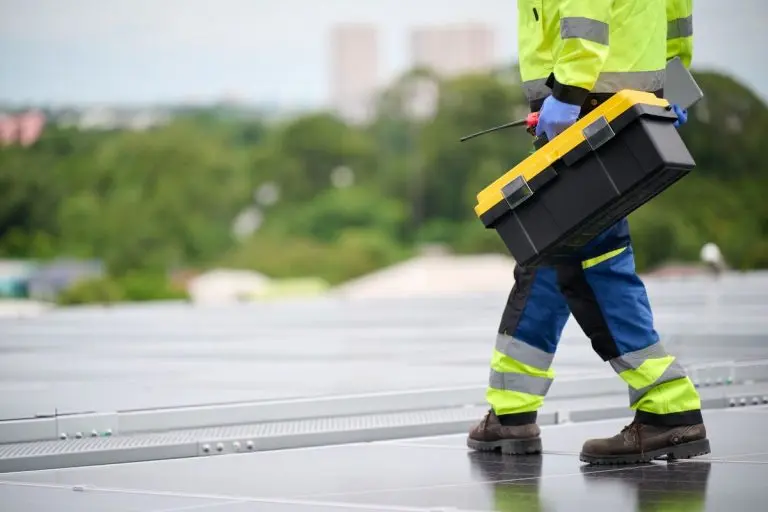 guy holding toolbox inspecting commercial roof