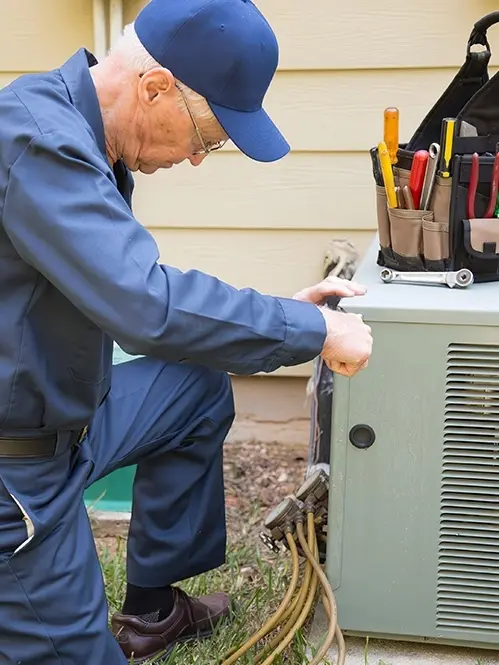 AC Repair - Technician working on outdoor AC unit.