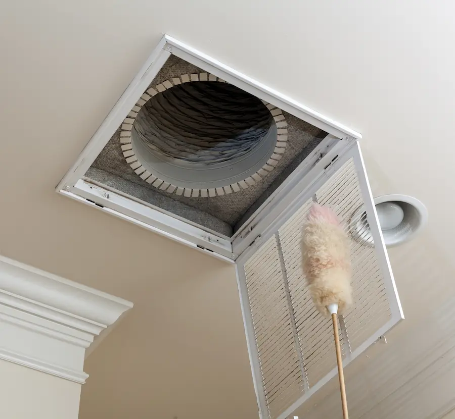 Wool Duster cleaning a duct in the roof.