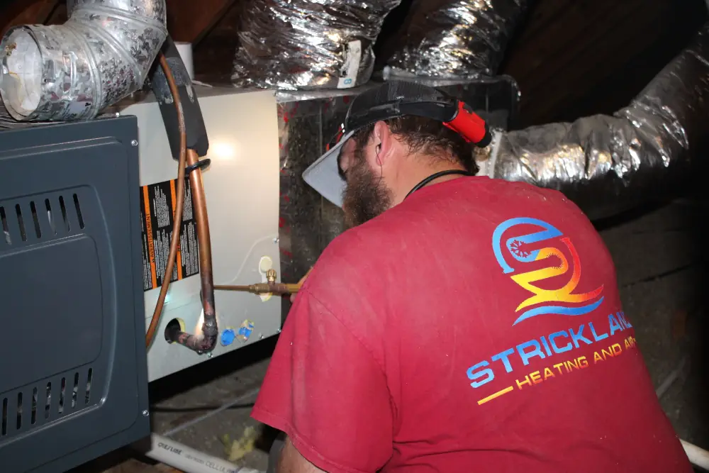 Furnace Tune Ups in Azle, TX - Strickland technician working on a furnace.