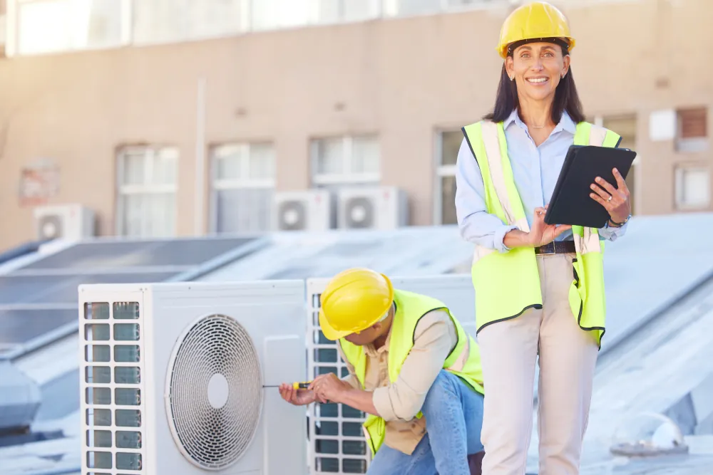 Air conditioner, building maintenance and teamwork with tablet, smile and development with engineer