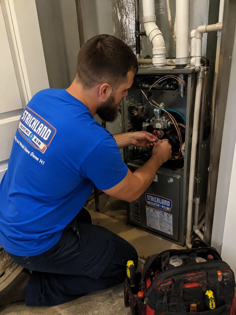 Strickland worker fixing furnace