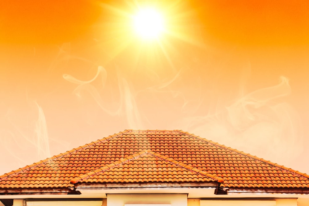 Sun shining over tile roof