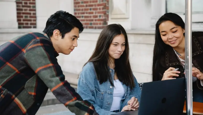 students looking at laptop