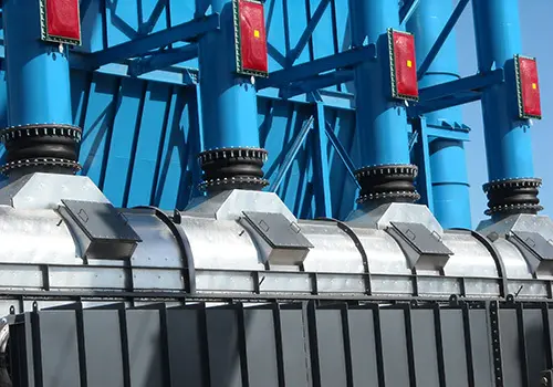 palm-frond-biofuel-dust-explosion-vents | Sly Air Pollution Control Close-up of blue steel structural framework with red warning lights and silver mechanical fittings on an industrial setup