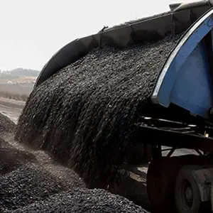Piles of processed coal next to a rail siding waiting to be put on a train for transporting to a coastal port