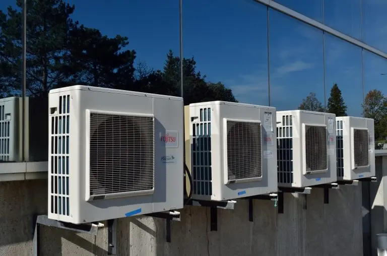 Outdoor air conditioner condenser unit installed at residential property