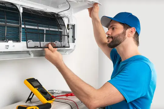 HVAC technician on a residential service call for air conditioning repair