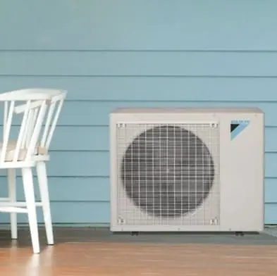 Mini-split condenser unit installation on exterior of home by Berner A/C & Heat