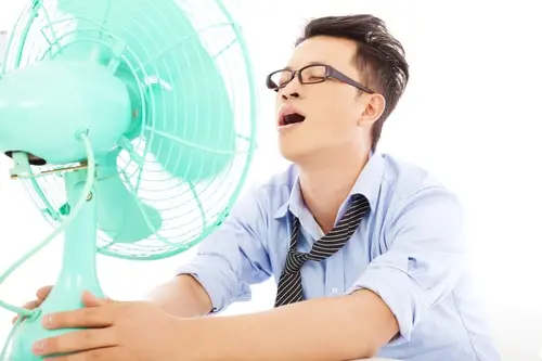 business man suffering a hot summer heat with fans