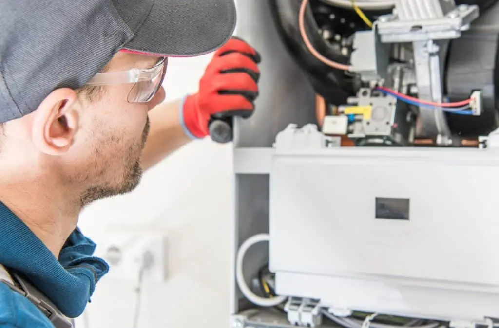 HVAC service technician working on air conditioning system for Berner A/C & Heat
