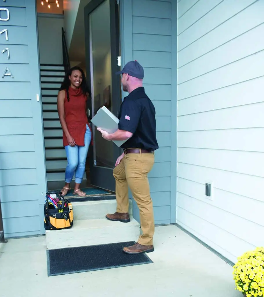 Amana certified HVAC technician performing in-home service call