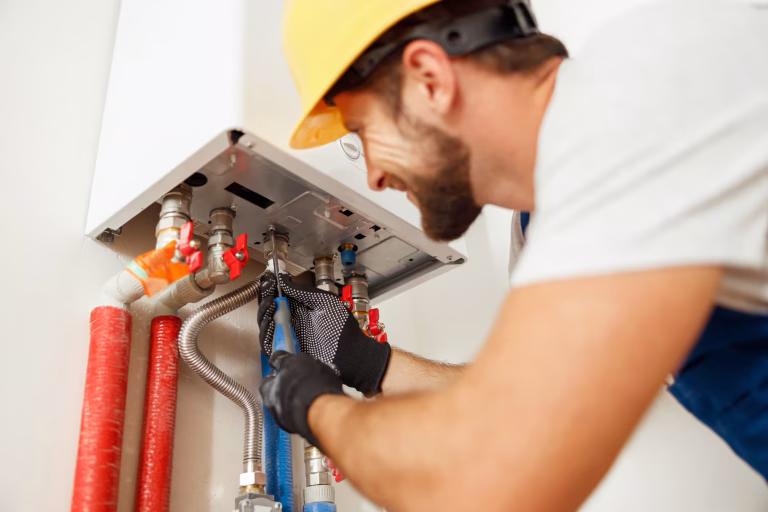 Professional HVAC technician working on residential air conditioning unit
