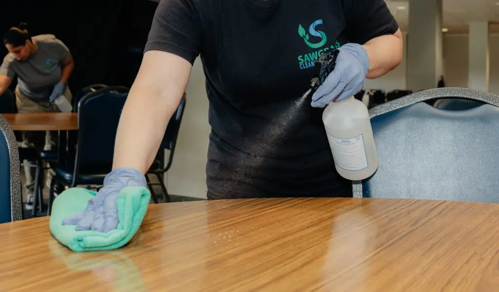 Sawgrass Cleaning technician sanitizing surface in an office