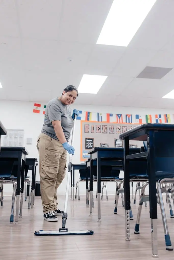 Janitor mopping LVT flooring in a school