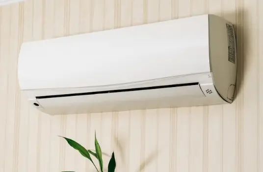 Mounted white wall air conditioner on a striped wall.