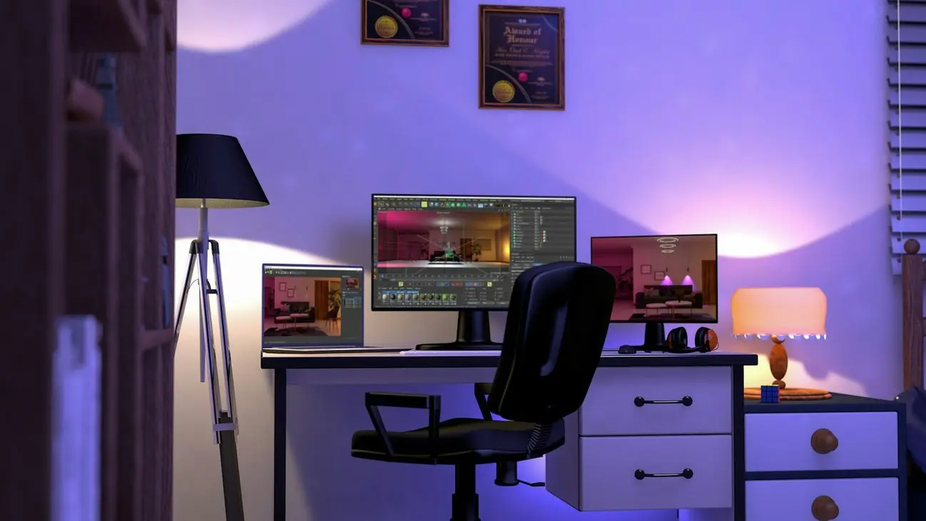 Cozy office setup with a laptop, dual monitors, a sleek black chair, and warm ambient lighting from lamps, awards on the wall.
