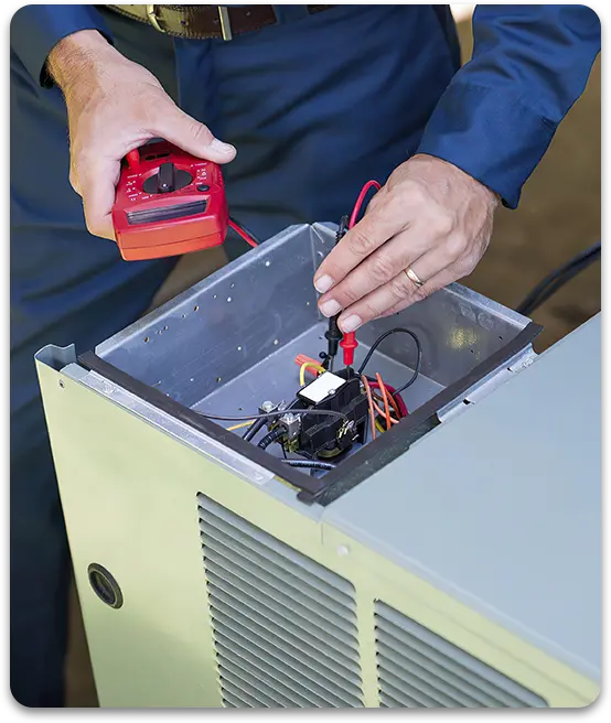 Technician using a multimeter to test an HVAC unit's wiring.