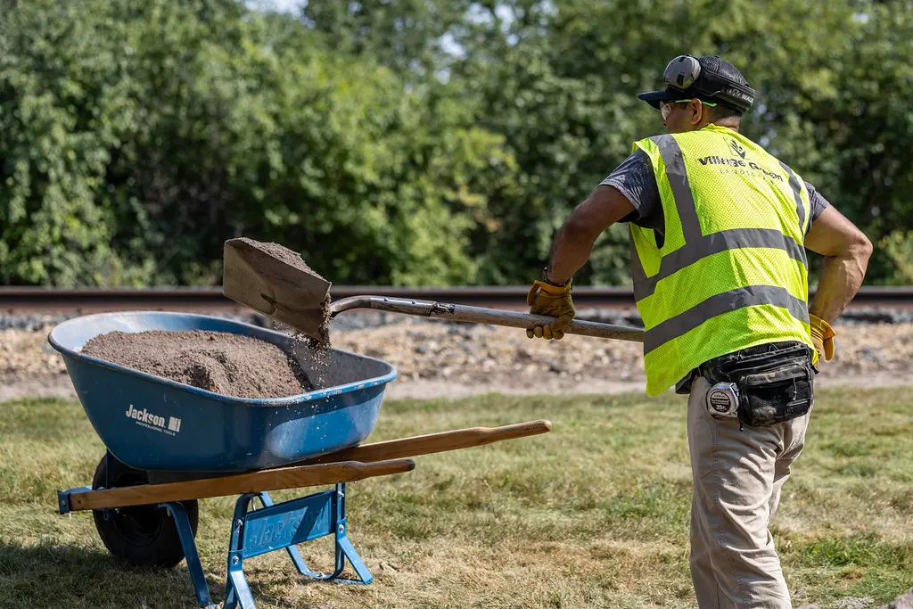 employee shoveling sand