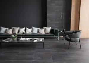 a living room with black tiles and flooring