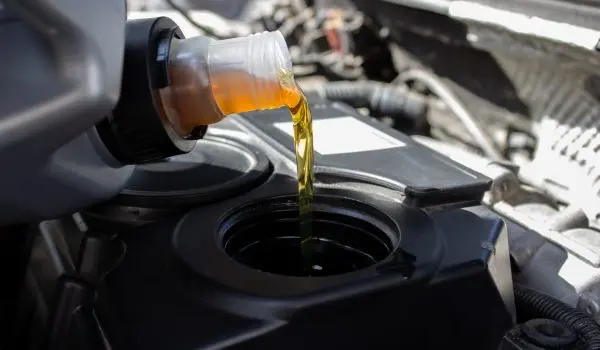 Refueling and pouring oil quality into the engine motor car Transmission and Maintenance Gear .Energy fuel concept. selective focus