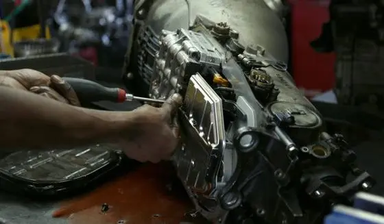 Mechanic Working on Car Transmission BMW & MINI OEM Parts Winston Salem